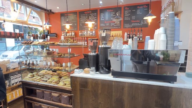 Espresso machine and pastry cabinet at the counter